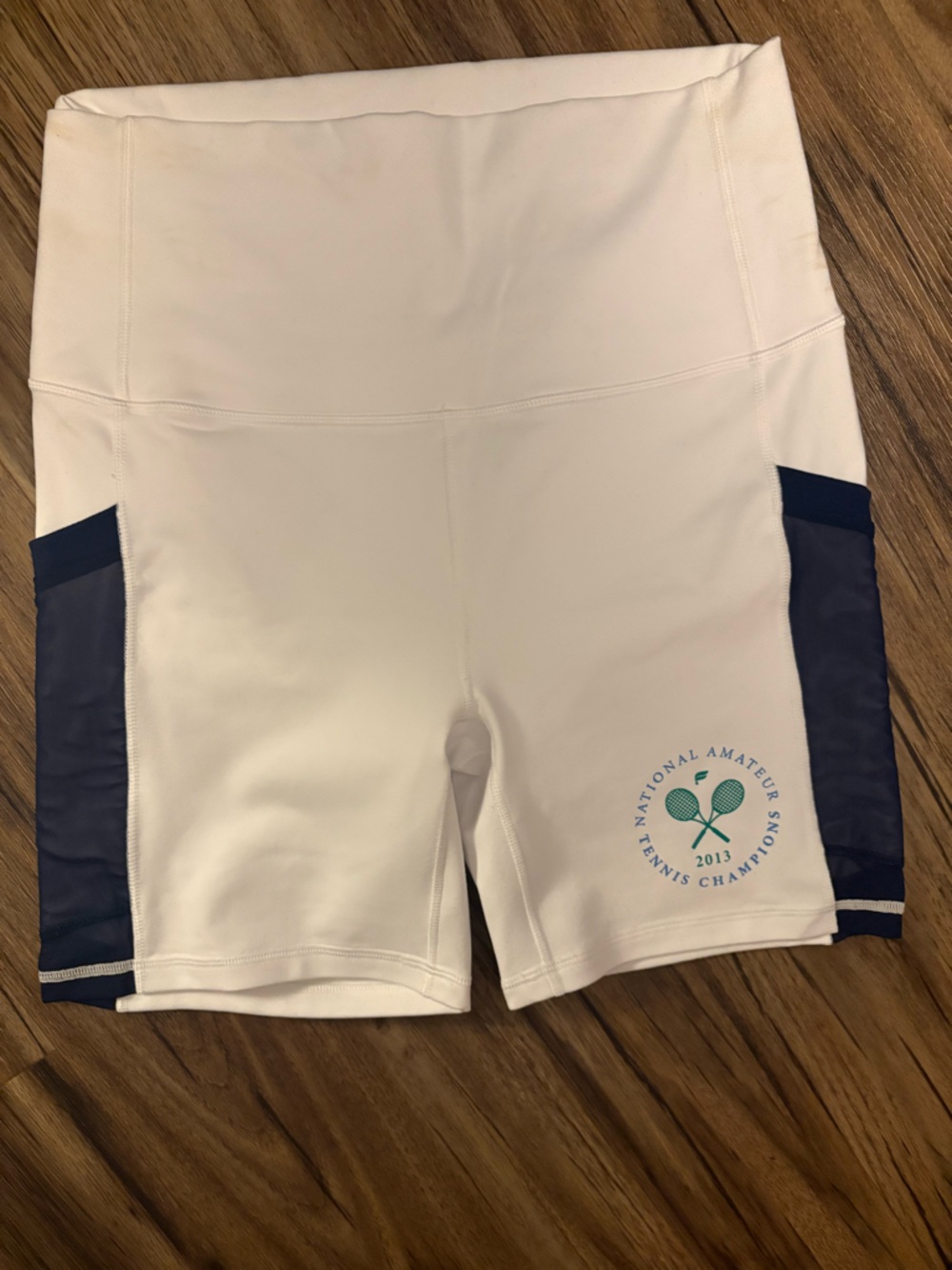 Fabletics White Bike Shorts with Navy Panels and Teal Logo
